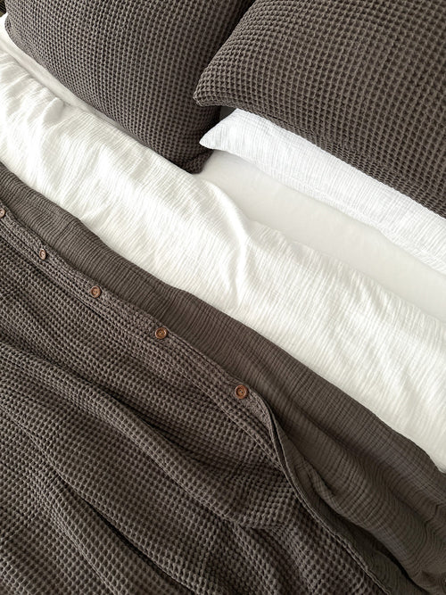 Organic cotton pillow covers styled on a natural linen bed — soft, breathable, and eco-conscious.