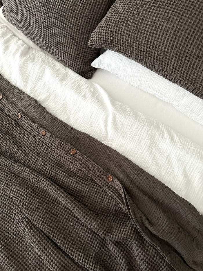 Organic cotton pillow covers styled on a natural linen bed — soft, breathable, and eco-conscious.